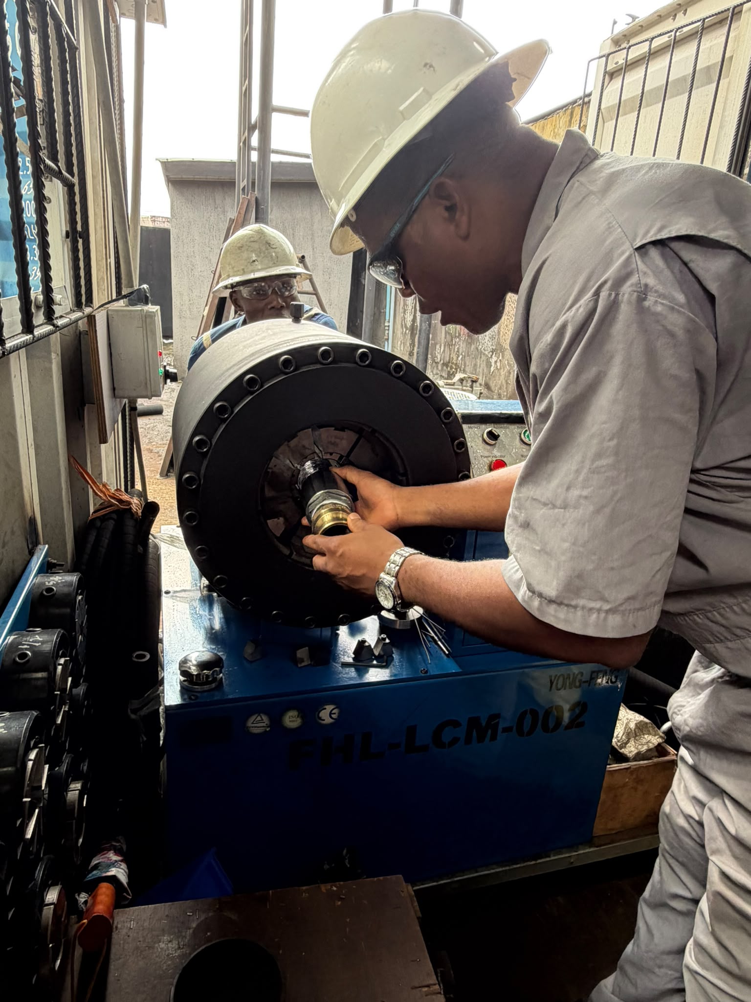 A Fabec technician preparing a hydraulic hose assembly on site